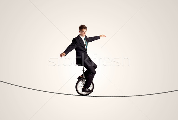 Сток-фото: Extreme · деловой · человек · верховая · езда · одноколесном · велосипеде · веревку · человека