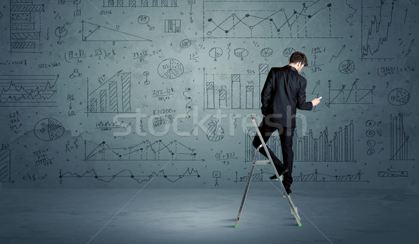 Man on ladder drawing charts Stock photo © ra2studio