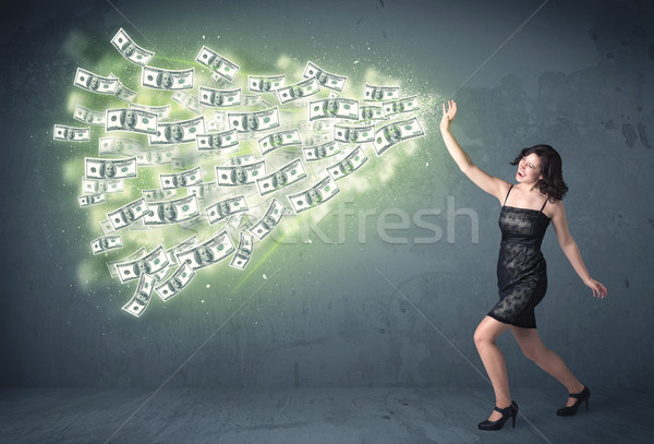 Stock photo: Business person throwing a lot of dollar bills concept