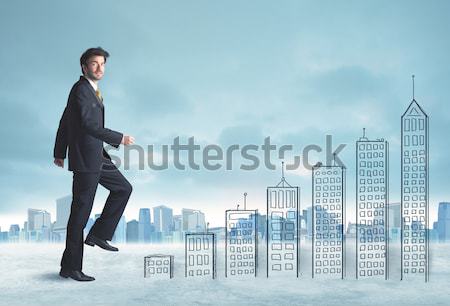 Człowiek biznesu wspinaczki w górę budynków miasta Zdjęcia stock © ra2studio