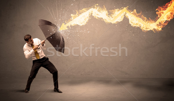 Uomo d'affari fuoco arrow ombrello pioggia Foto d'archivio © ra2studio