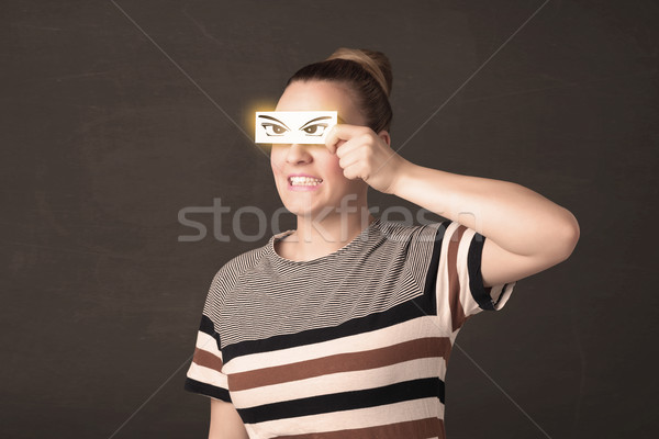 Stock photo: Cool youngster looking with a paper hand drawn eyes