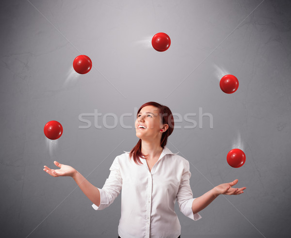 young girl standing and juggling with red balls Stock photo © ra2studio