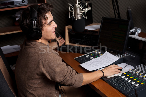 Radio młody człowiek mikrofon słuchawek muzyki strony Zdjęcia stock © ra2studio