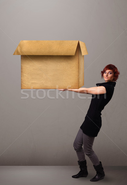 Young woman holding an empty cardboard box Stock photo © ra2studio