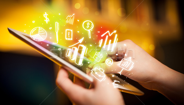 Stock photo: Hand touching tablet pc, charts concept