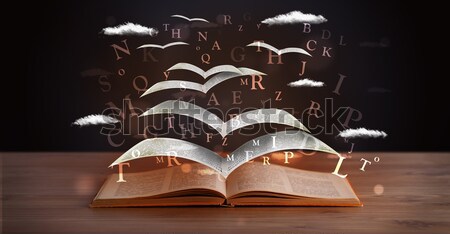 Pages and glowing letters flying out of a book  Stock photo © ra2studio