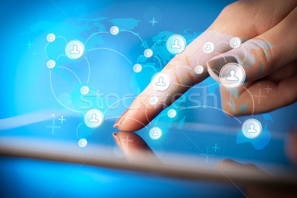 Hand touching tablet pc, social network concept Stock photo © ra2studio