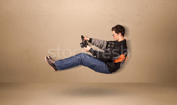 Happy funny man driving a flying car concept Stock photo © ra2studio