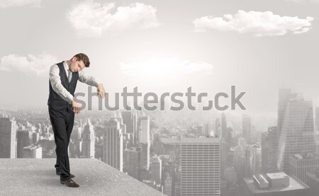 Businessman standing on the edge of rooftop Stock photo © ra2studio