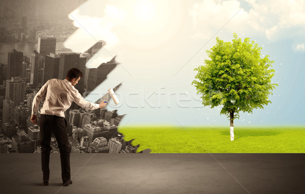 Salesman painting tree instead of city Stock photo © ra2studio