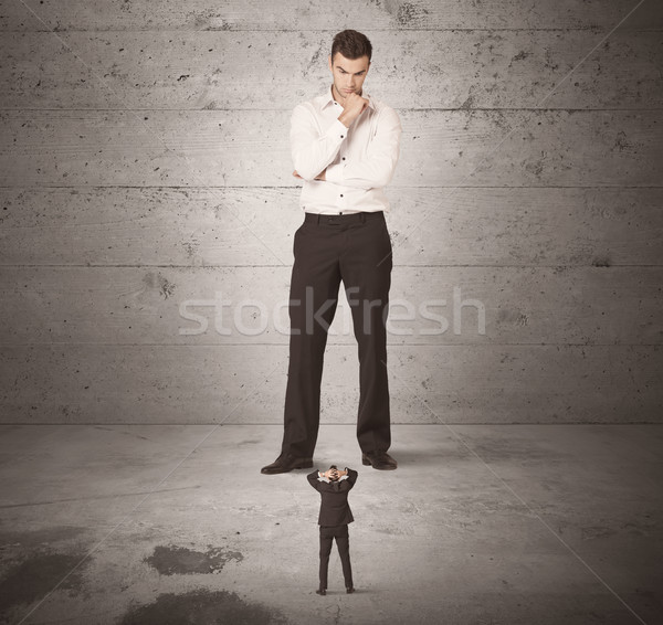 Huge business guy looking at small coworker Stock photo © ra2studio