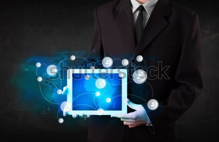 Young person holding talbet with communication technology concep Stock photo © ra2studio