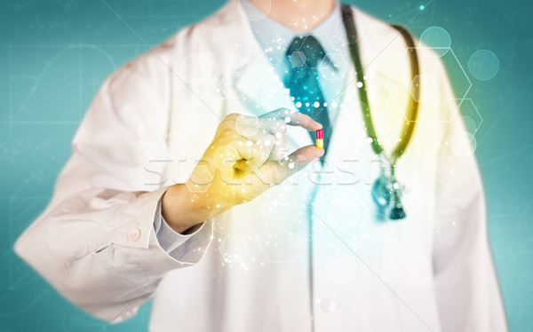 A doctor in tie holding a pill Stock photo © ra2studio