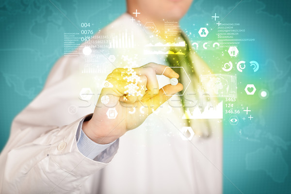 Doctor holding a pill between fingers Stock photo © ra2studio