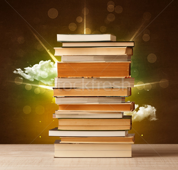 Magical books with ray of magical lights and colorful clouds Stock photo © ra2studio