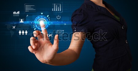 Young tech woman pressing high technology control panel screen c Stock photo © ra2studio