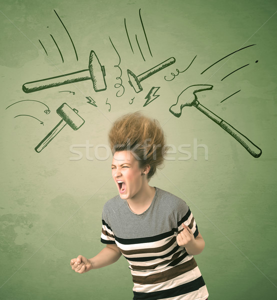 Stock photo: Tired woman with hair style and headache hammer symbols 