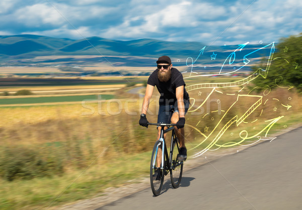 Young cyclist in with meadow background Stock photo © ra2studio