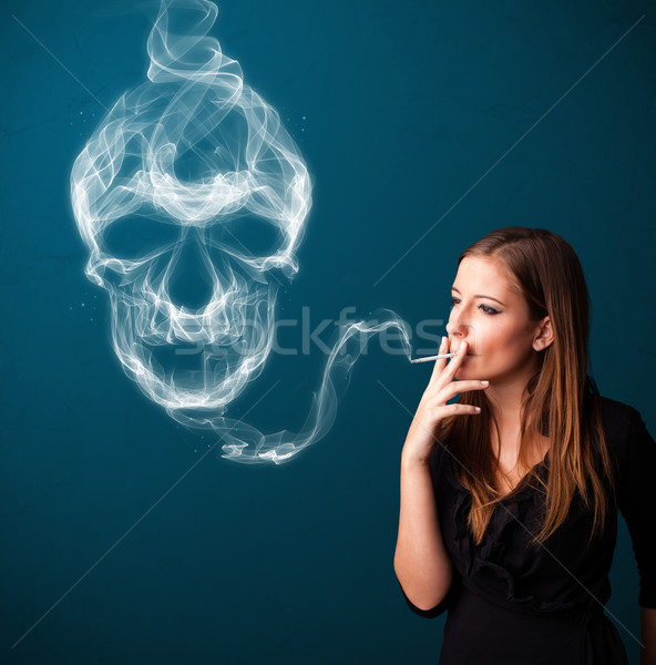 Young woman smoking dangerous cigarette with toxic skull smoke  Stock photo © ra2studio