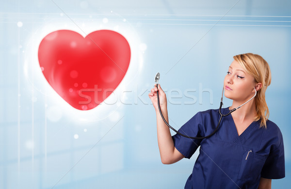 Młodych pielęgniarki uzdrowienie czerwony serca dość Zdjęcia stock © ra2studio