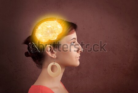 Young girl thinking with glowing brain illustration Stock photo © ra2studio