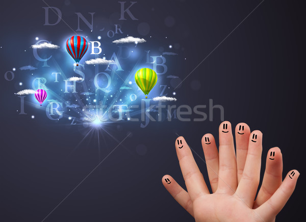 Happy cheerful smiley fingers looking at hot air balloons in the cloudy sky Stock photo © ra2studio