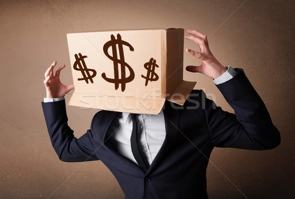 Businessman gesturing with a cardboard box on his head with doll Stock photo © ra2studio
