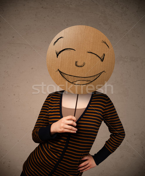 Young woman holding a smiley face board Stock photo © ra2studio