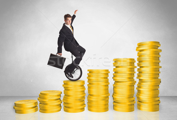 Business man riding monocycle up on coin graph Stock photo © ra2studio