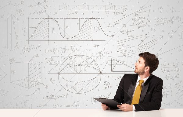 Stock photo: Businessman with business calculations background