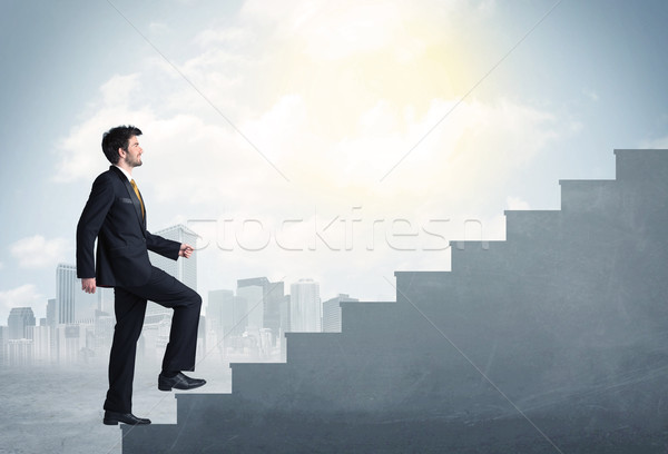 Biznesmen wspinaczki w górę konkretnych schody miasta Zdjęcia stock © ra2studio