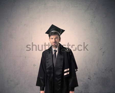 Stock photo: Portrait of a young graduate student on grungy background