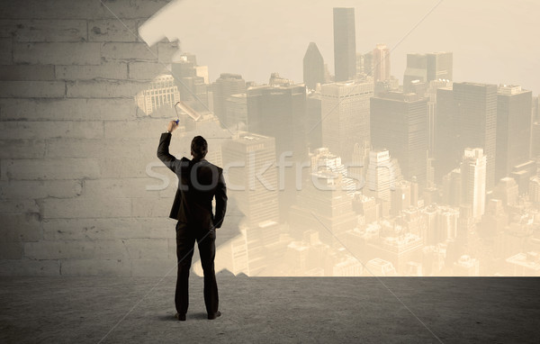 Salesman painting city scape on wall Stock photo © ra2studio