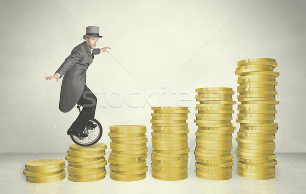Business man riding monocycle up on coin graph Stock photo © ra2studio