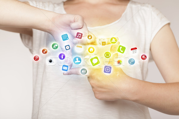 Stock photo: Hands creating a form with mobile app icons