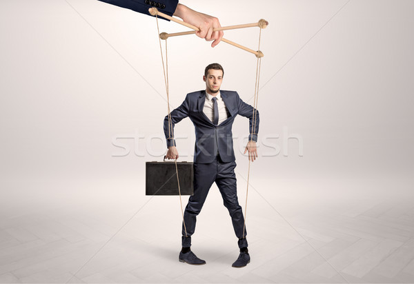 Stock photo: Puppet businessman leaded by a huge hand