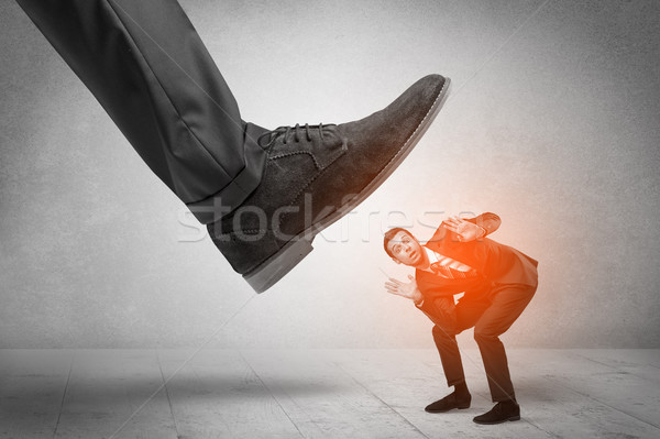 Large foot stepping down small man Stock photo © ra2studio