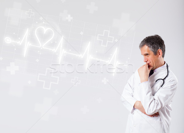 Stock photo: Doctor examinates heartbeat with abstract heart