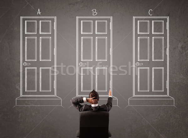 Businessman choosing the right door Stock photo © ra2studio