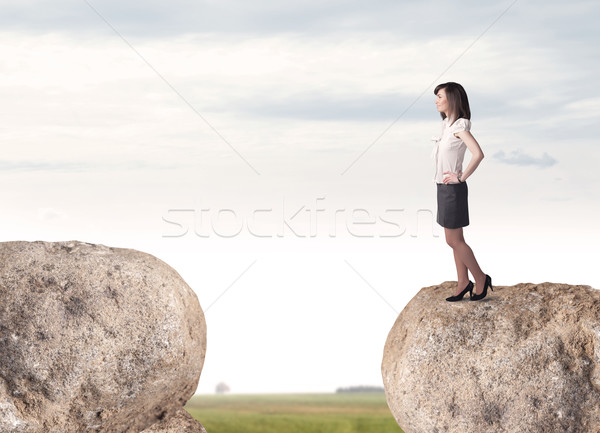 Businesswoman on rock mountain Stock photo © ra2studio