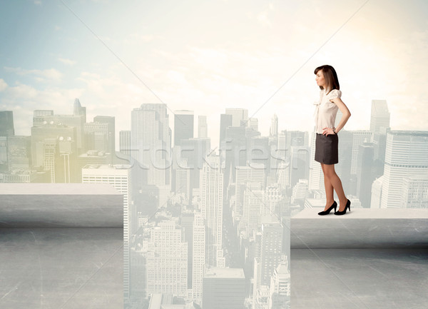 Businesswoman standing on the edge of rooftop Stock photo © ra2studio