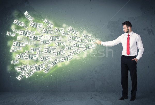 Stock photo: Business person throwing a lot of dollar bills concept