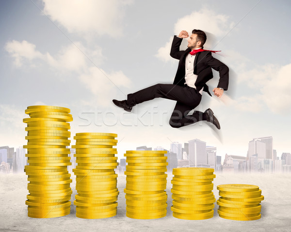 Bem sucedido homem de negócios saltando para cima moeda de ouro dinheiro Foto stock © ra2studio