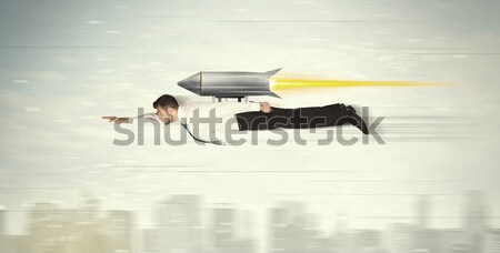 Stock photo: Superhero business man flying with jet pack rocket above the cit