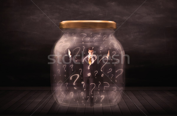 Businessman locked into a jar with question marks concept Stock photo © ra2studio