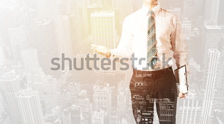 Business man looking at overlay city background Stock photo © ra2studio