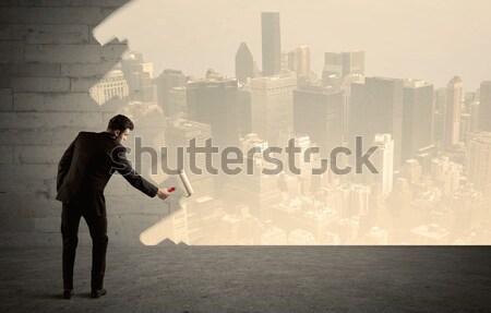 Salesman painting city scape on wall Stock photo © ra2studio