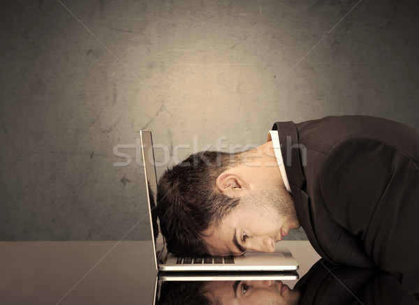 Frustrated businessman's head on keyboard Stock photo © ra2studio