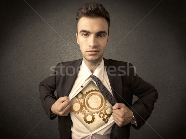 Stock photo: Businessman tearing shirt off and machine cog wheel shows